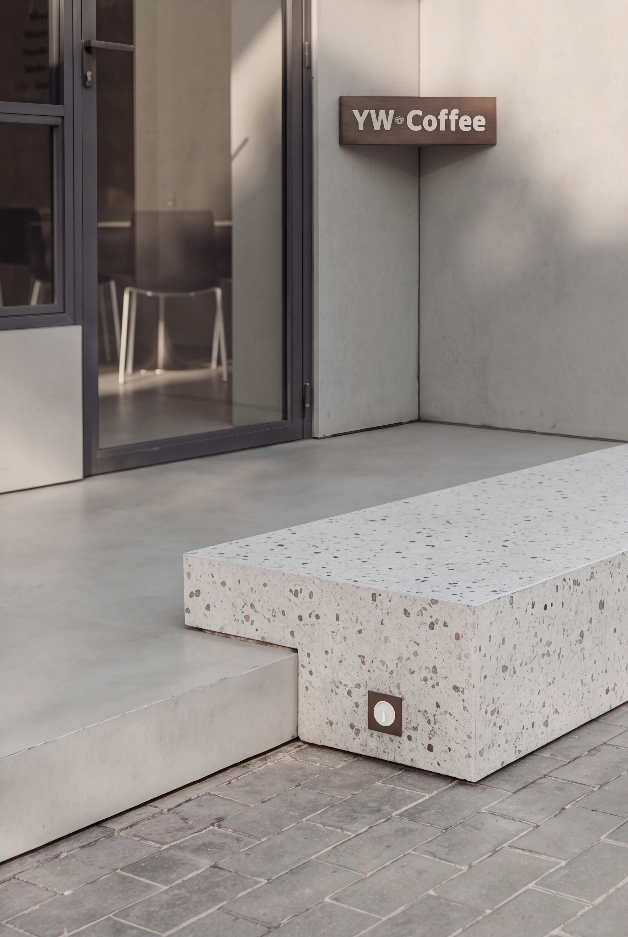 YW Coffee entrance detail with concrete step and signage